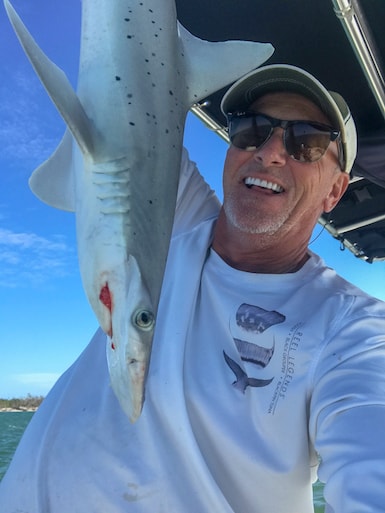 Captain Jim Edgar Holding a Shark Near Marco Island